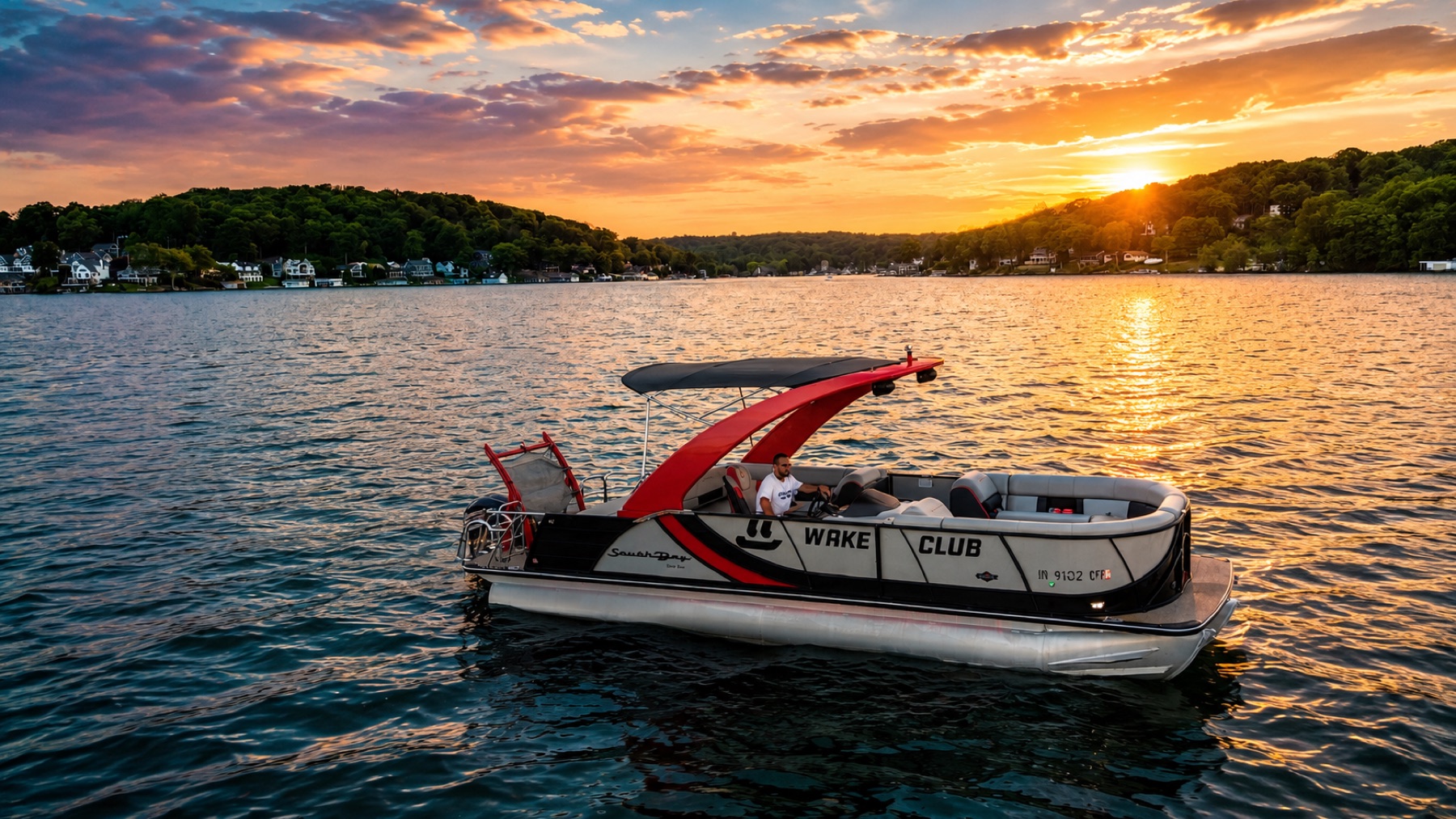Wake Club Sport Tritoon pontoon at sunset on Lake Hopatcong