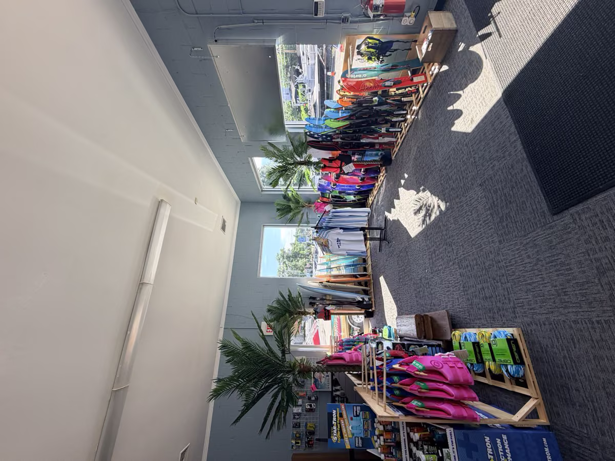 Life vests, tubes and water skis lined up inside the Wake Club store